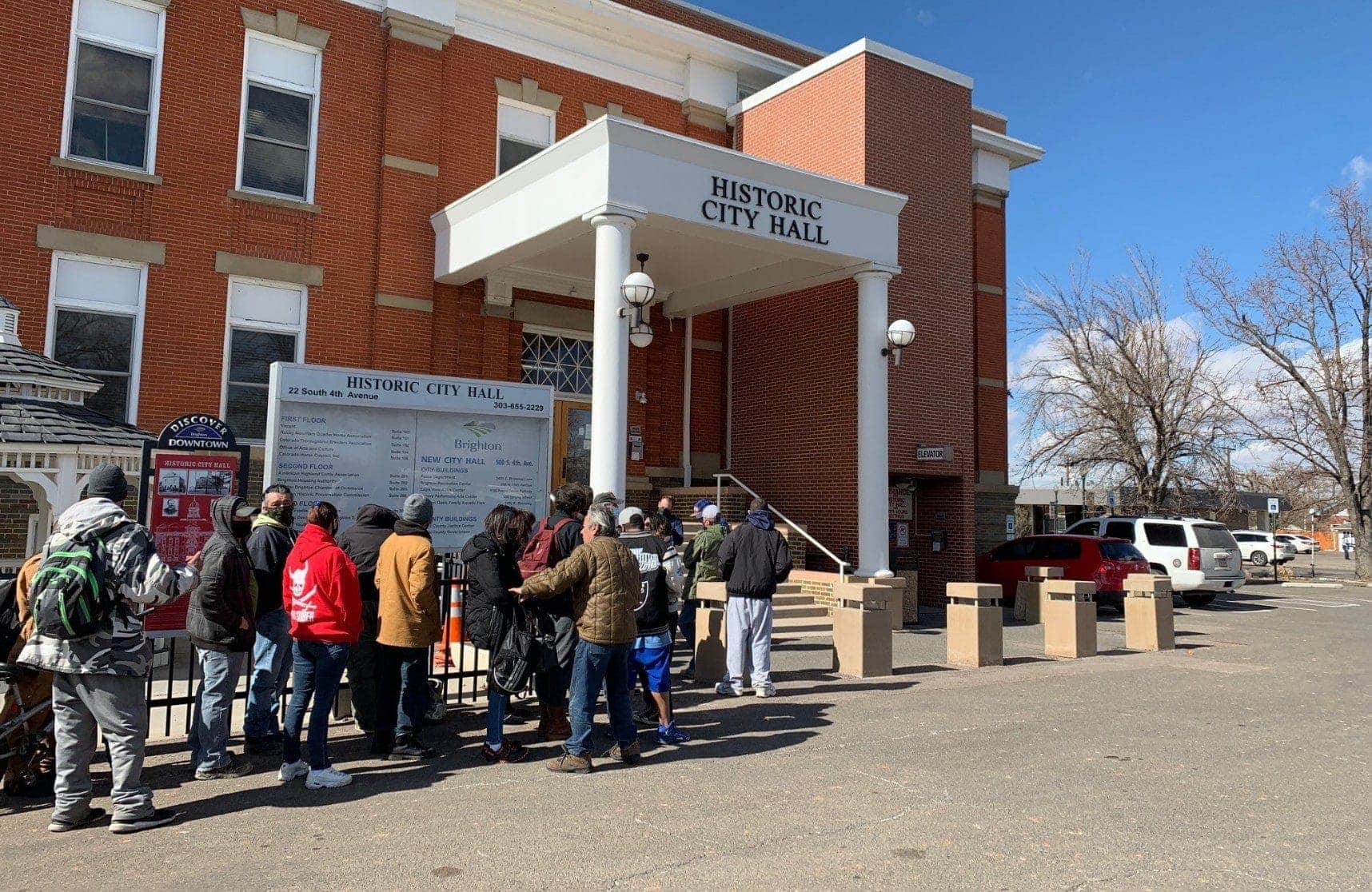 People waiting in line outside Historic City Hall for emergency shelter intake